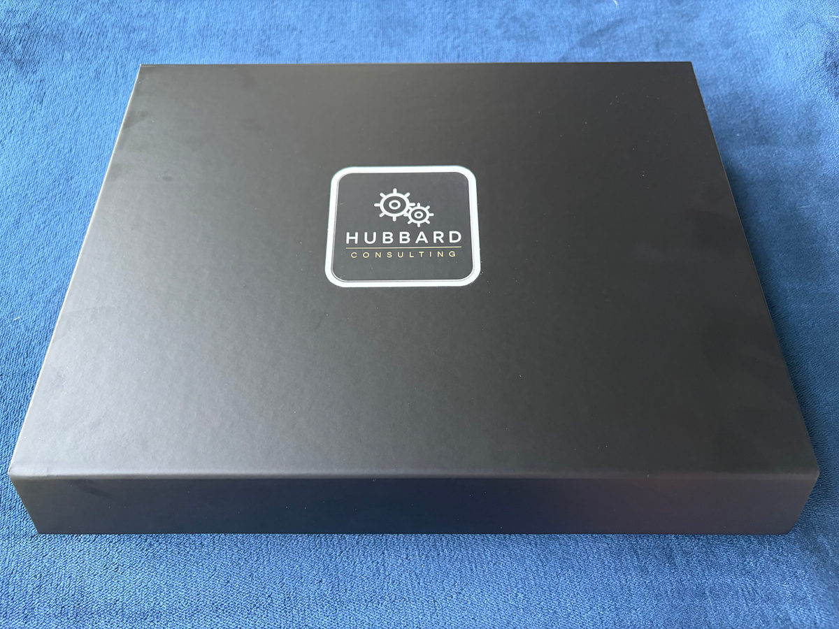 Closed Hubbard Consulting presentation box with Hubbard Consulting branding.